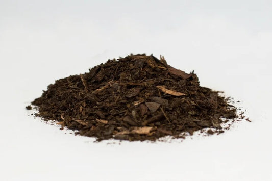 Heap of dark brown compost on a white background