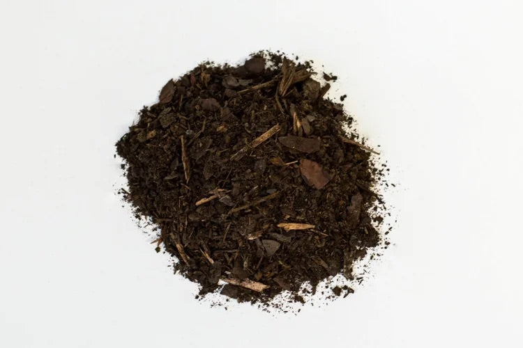 Heap of dark brown compost on a white background