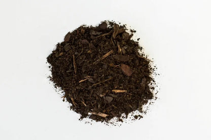 Heap of dark brown compost on a white background